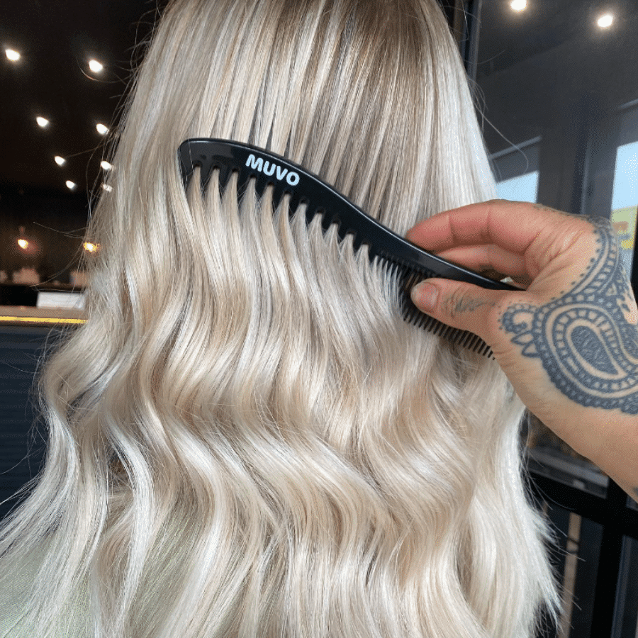 MUVO Wave Comb product image MUVO wave comb being combed through platinum blonde hair.