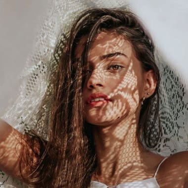 warm brown haired lady with white lace veiled partly over her hair warm brown haired lady with white lace veiled partly over her hair