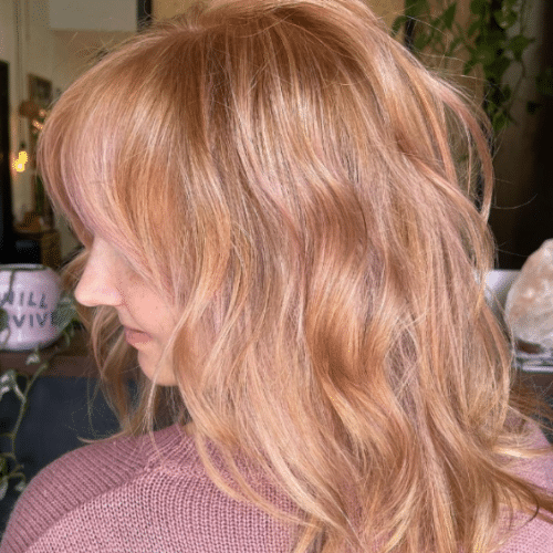 Woman with ginger hair and pink highlights throuout